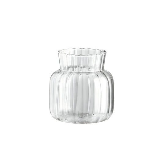 clear glass vases with rose and small white flowers on wooden tray