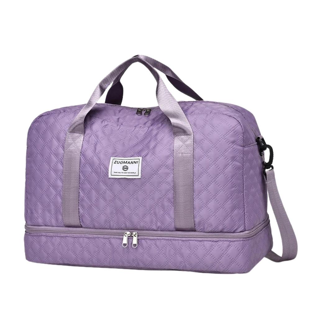 woman carrying pink travel duffel bag beside a suitcase
quilted travel duffel bags in pink and cream colors
lightweight nylon duffel bag placed on blue luggage
large soft travel bag with zipper closure and shoulder strap
weekender duffel bag shown in a travel setting