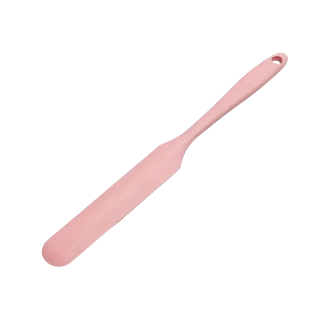 cake frosting spatula tools shown beside a wooden cutting board