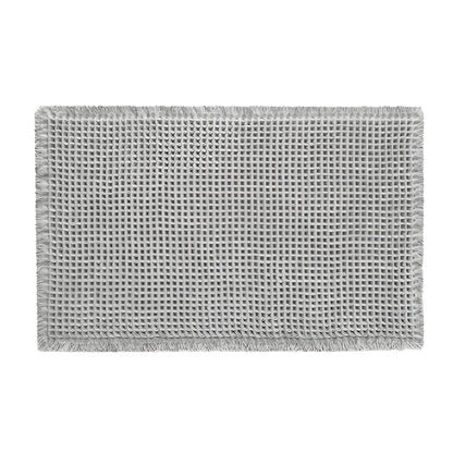 beige Bath Rugs & Mats with woven texture placed beside a shower
gray bathroom rug with raised waffle pattern and fringed edges
microfiber bath mat on bathroom floor with foot stepping on it
textured bathroom mats shown in beige and gray color options