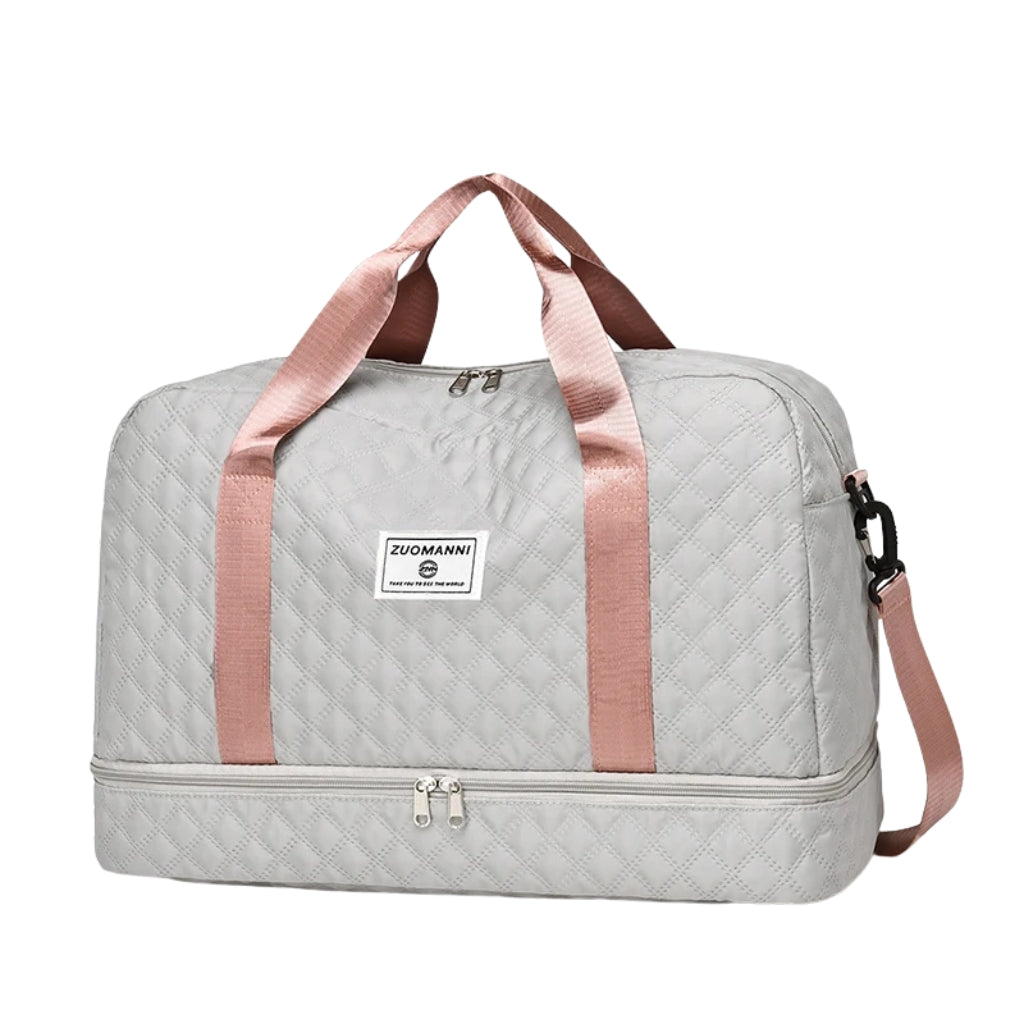 woman carrying pink travel duffel bag beside a suitcase
quilted travel duffel bags in pink and cream colors
lightweight nylon duffel bag placed on blue luggage
large soft travel bag with zipper closure and shoulder strap
weekender duffel bag shown in a travel setting