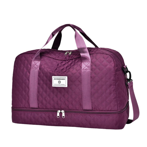 woman carrying pink travel duffel bag beside a suitcase
quilted travel duffel bags in pink and cream colors
lightweight nylon duffel bag placed on blue luggage
large soft travel bag with zipper closure and shoulder strap
weekender duffel bag shown in a travel setting