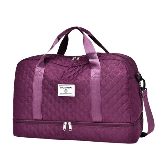 woman carrying pink travel duffel bag beside a suitcase
quilted travel duffel bags in pink and cream colors
lightweight nylon duffel bag placed on blue luggage
large soft travel bag with zipper closure and shoulder strap
weekender duffel bag shown in a travel setting