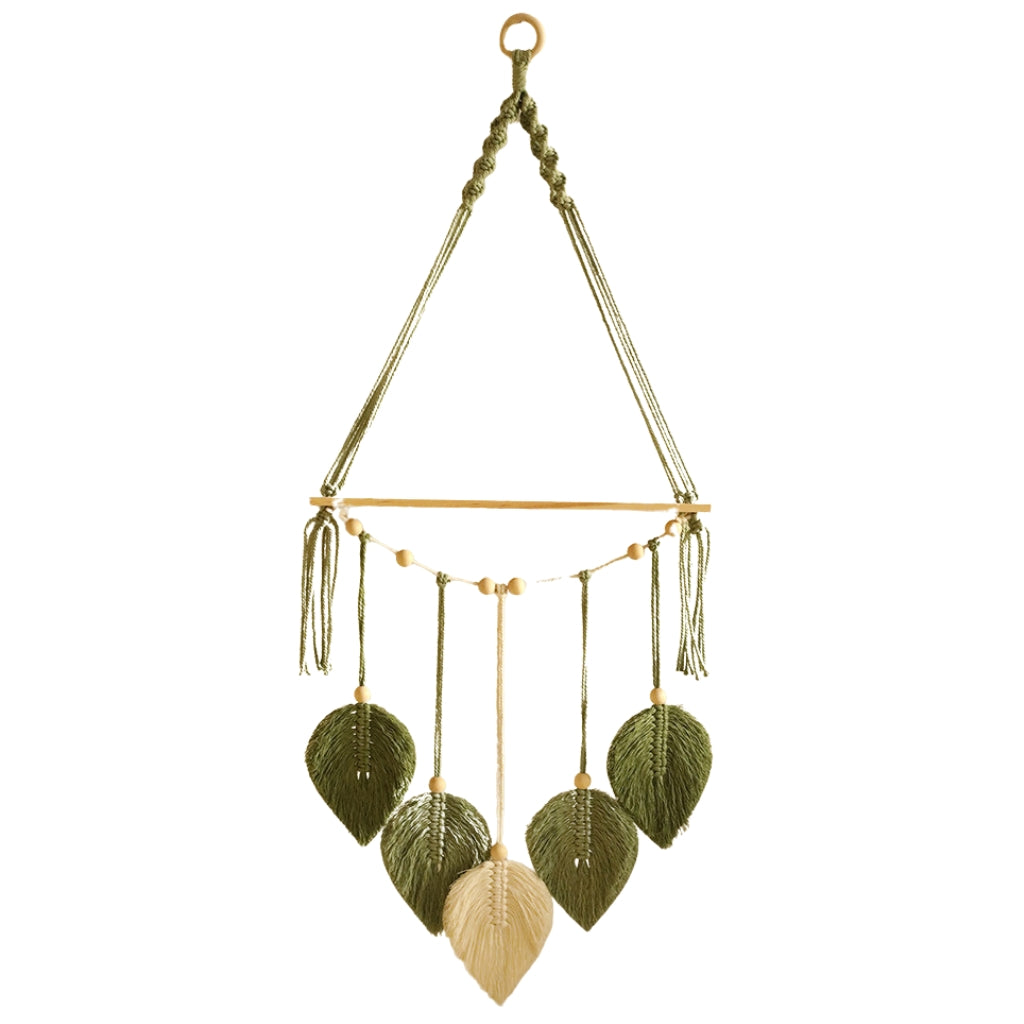 boho wall shelves with macrame leaf design hanging on bedroom wall
wooden floating shelf with green macrame leaves and bead accents